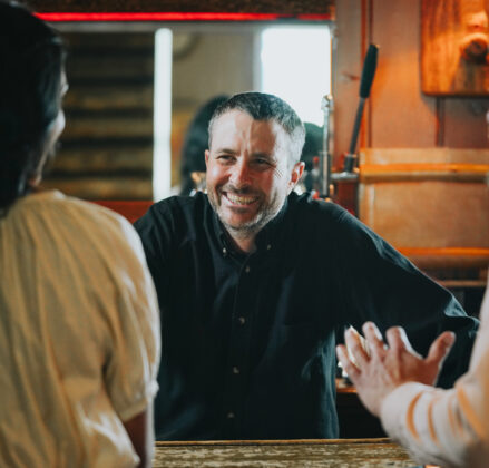 Bartender and customers laughing