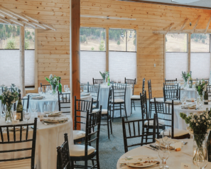 A bright dining room decorated for a wedding reception