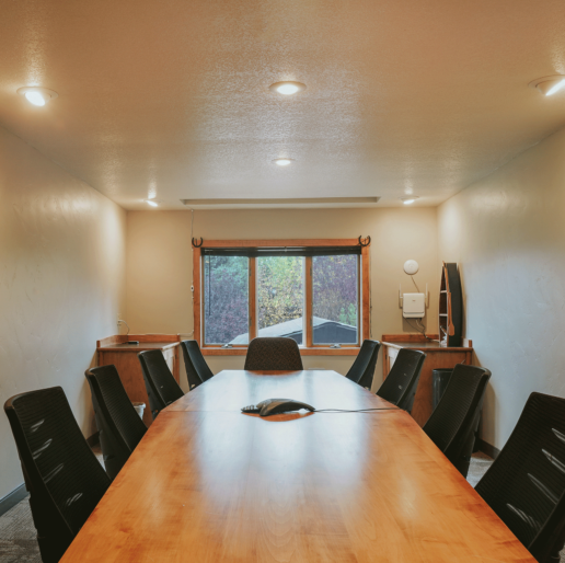 A sleek and modern table surrounded by several chairs