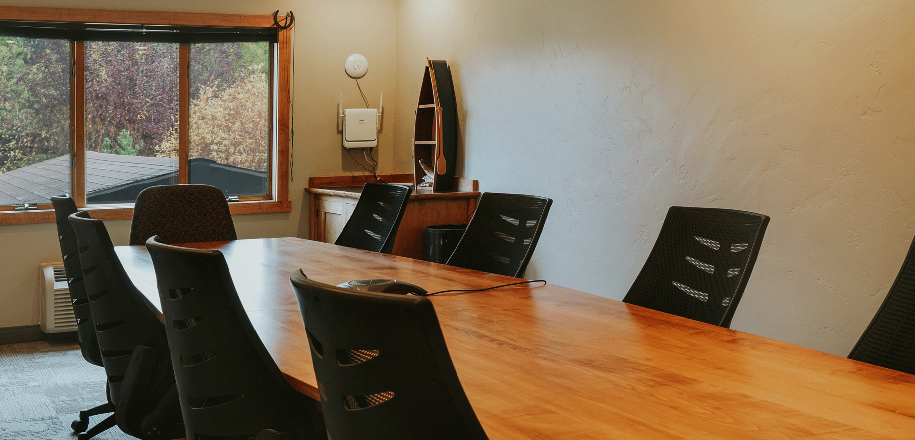 A sleek and modern table surrounded by several chairs