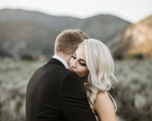 Bride and groom hugging with Montana landscape in the background
