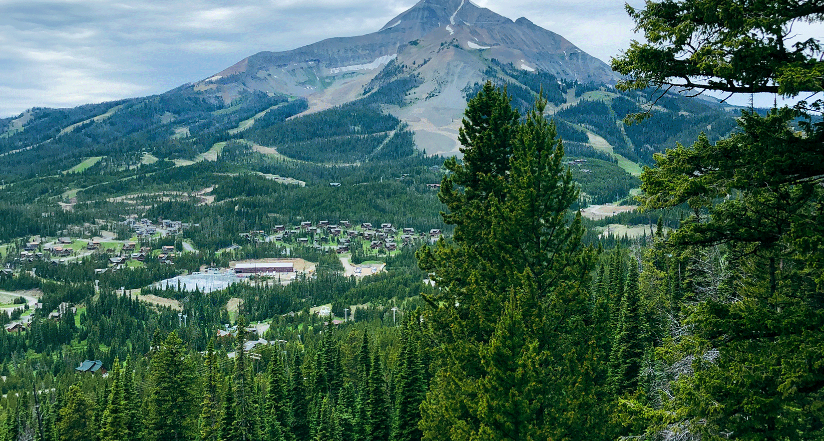 A green landscape with Lone Peak in the background