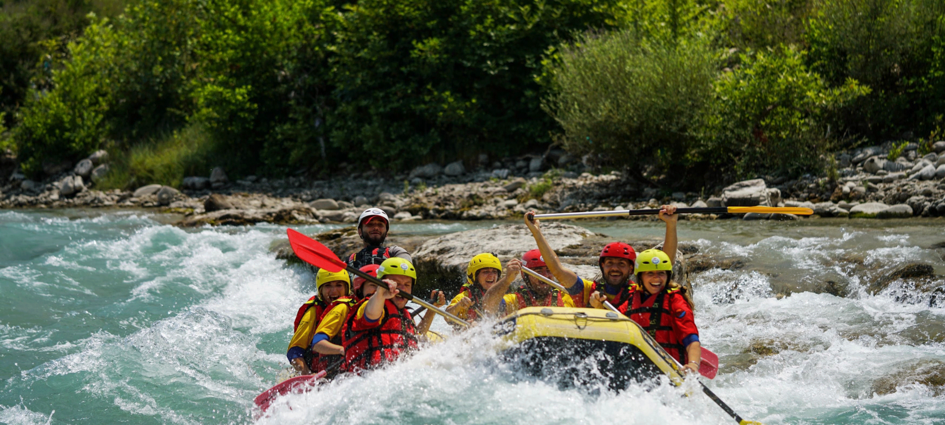 A group of people white water rafting