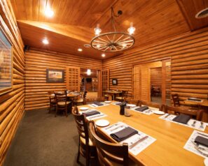A small private dining room with log cabin walls
