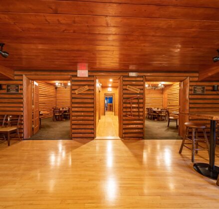 Three doorways, one leading to a long hallway and two opening into small private dining rooms
