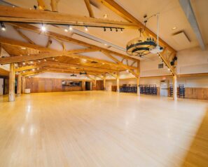 A large ballroom with ambient lighting and western decor