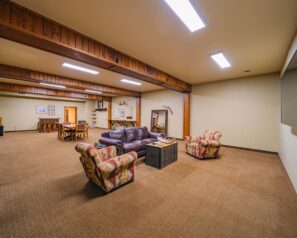 A large room with rustic decor and western themed furniture