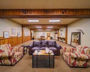 A large room with rustic decor and western themed furniture
